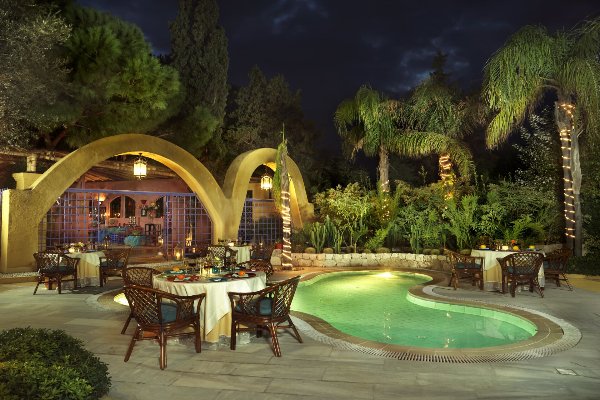 Table set in a serene poolside ambiance to savor delicious Mexican cuisine.