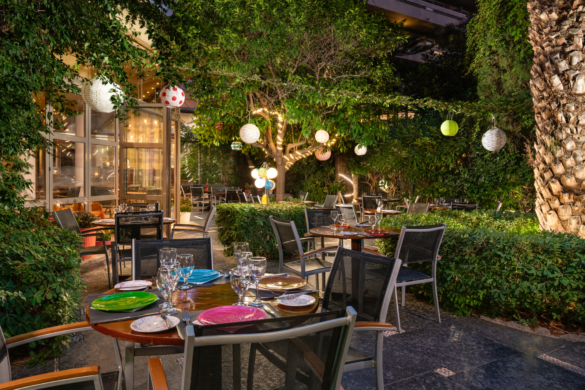 A beautifully arranged table in the outdoor space of Dionysos Grill, inviting you to indulge in a delightful dining experience.